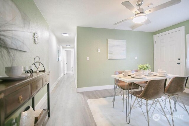 dining space featuring ceiling fan and light hardwood / wood-style flooring