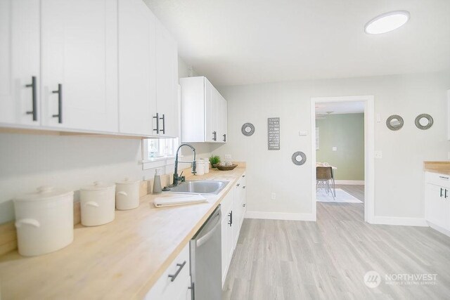 317 2nd Ave NW, Kelso, WA 98626 - kitchen with white cabinets, dishwasher, light countertops, and a sink