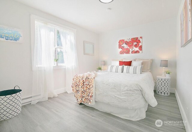 bedroom with hardwood / wood-style flooring