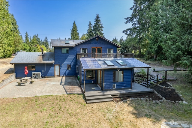 back of house featuring central AC and a yard