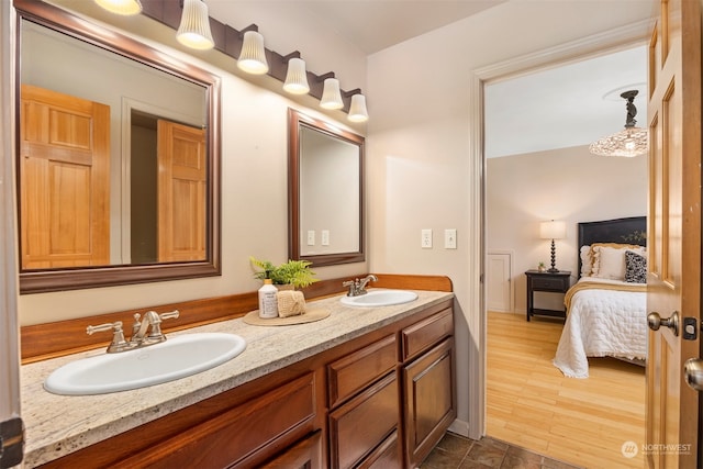 bathroom with dual vanity and hardwood / wood-style floors