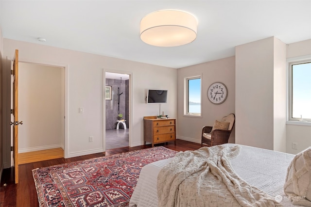 bedroom featuring multiple windows and dark hardwood / wood-style floors