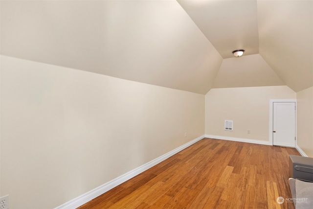 bonus room featuring vaulted ceiling and light hardwood / wood-style floors