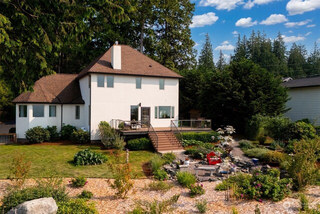 rear view of property with cooling unit, a deck, and a yard