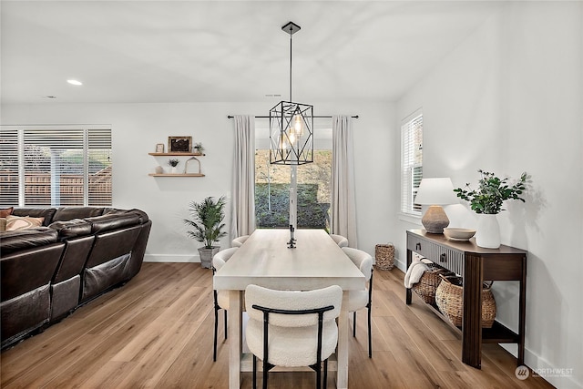 dining room featuring light hardwood / wood-style floors and an inviting chandelier