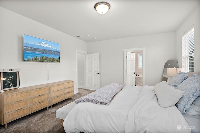 carpeted bedroom featuring ensuite bath