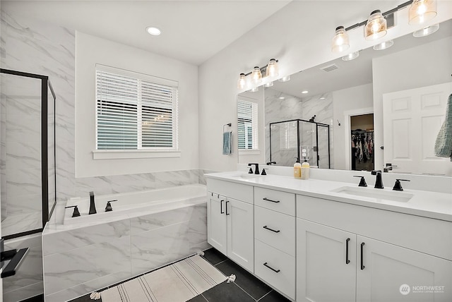 bathroom featuring separate shower and tub and vanity