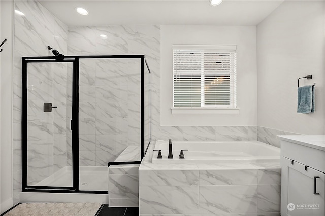 bathroom featuring separate shower and tub and vanity