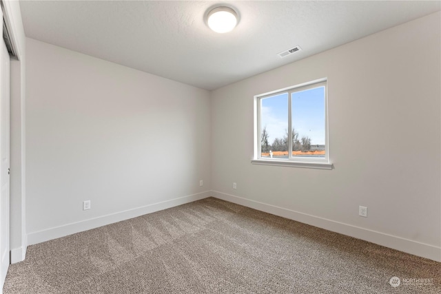 spare room featuring carpet flooring