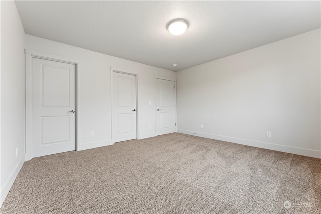 unfurnished bedroom featuring carpet and a textured ceiling