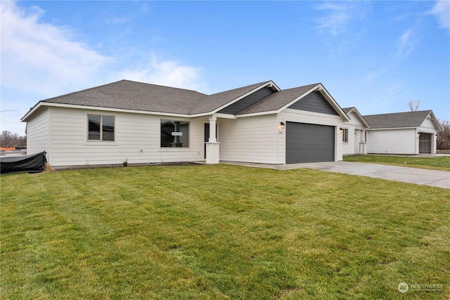 ranch-style house featuring a garage and a front lawn