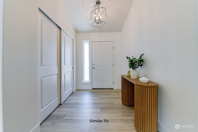 foyer featuring a chandelier and light hardwood / wood-style flooring