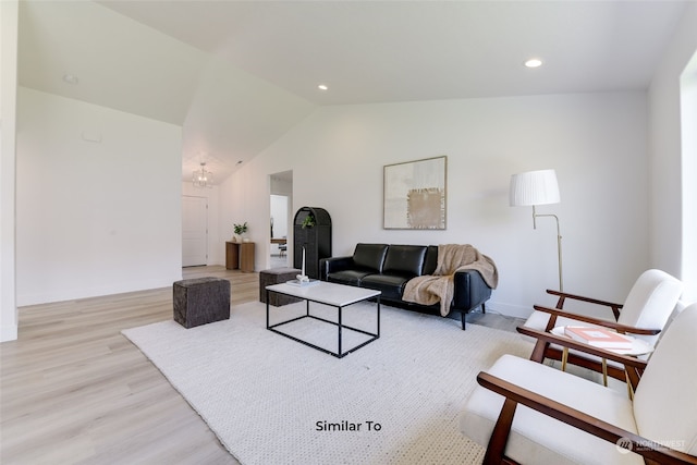 living room featuring vaulted ceiling and light wood-type flooring