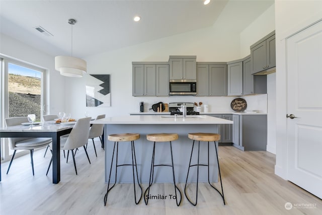 kitchen with stainless steel appliances, sink, pendant lighting, and gray cabinets