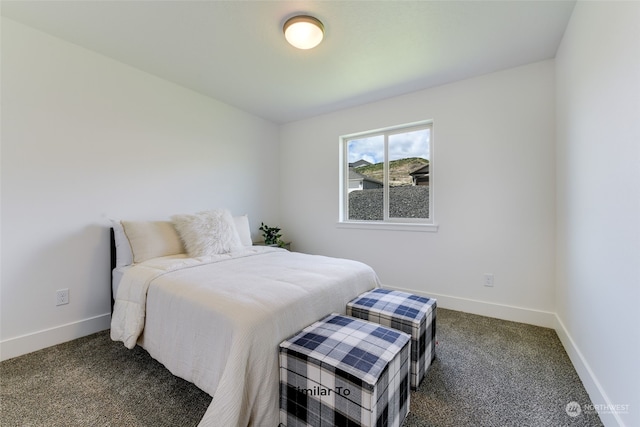 bedroom with dark colored carpet