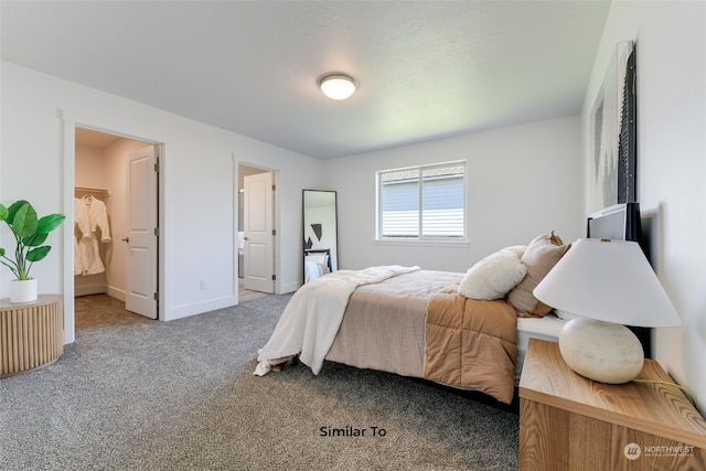 bedroom featuring a walk in closet and carpet flooring