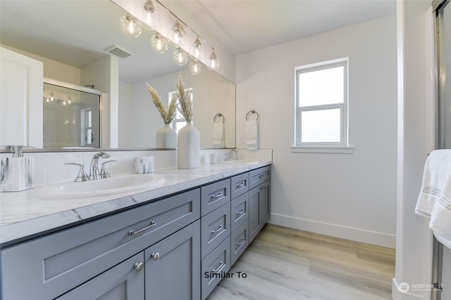 bathroom featuring vanity, a shower with shower door, and hardwood / wood-style floors