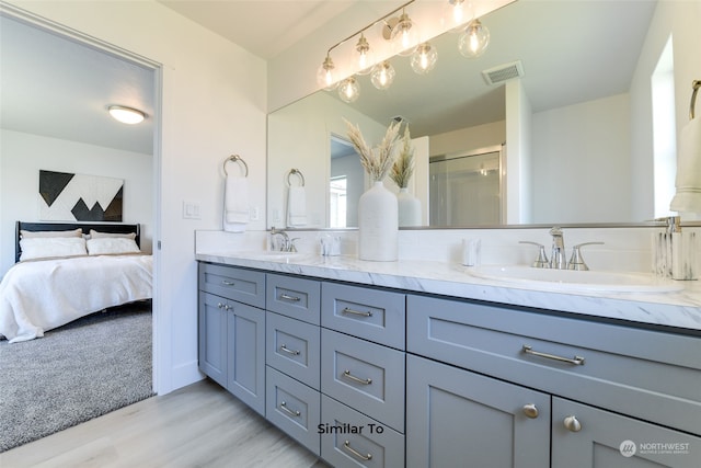 bathroom with vanity, hardwood / wood-style flooring, and walk in shower