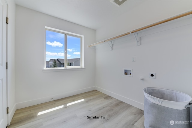 washroom featuring gas dryer hookup, washer hookup, hookup for an electric dryer, and light hardwood / wood-style floors