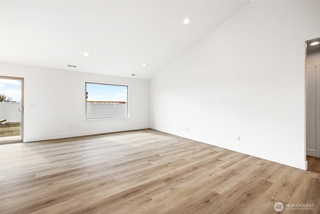 spare room with lofted ceiling, recessed lighting, visible vents, light wood-style flooring, and baseboards