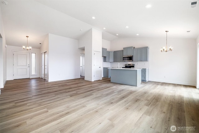 kitchen with visible vents, appliances with stainless steel finishes, a chandelier, and open floor plan