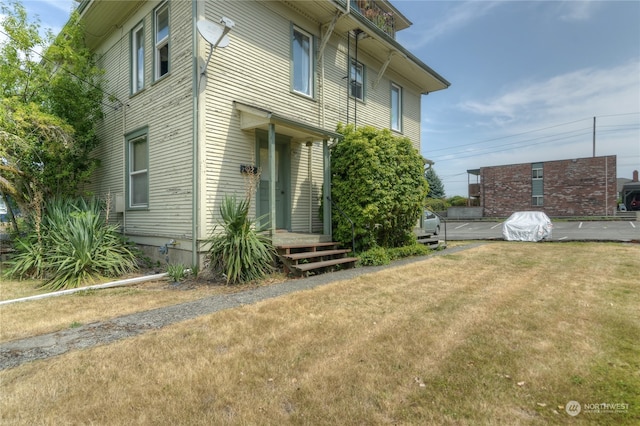 view of property exterior with a yard