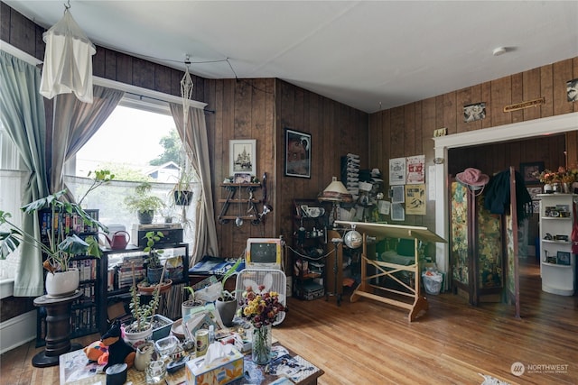 miscellaneous room featuring wood walls and wood-type flooring