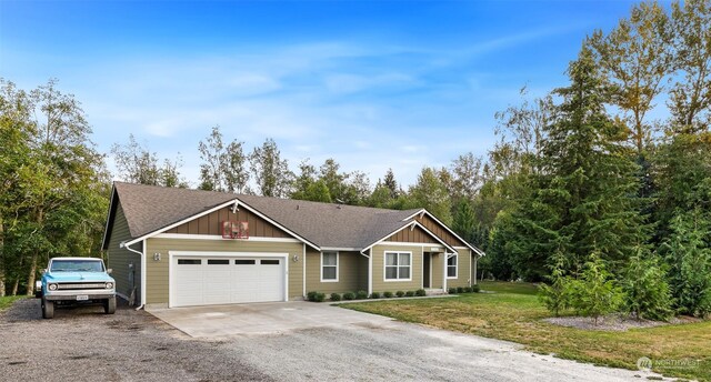 single story home featuring a garage and a front lawn