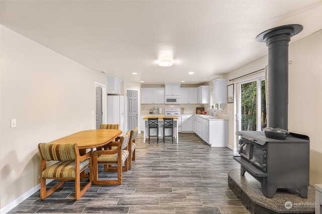 dining room with a wood stove and sink