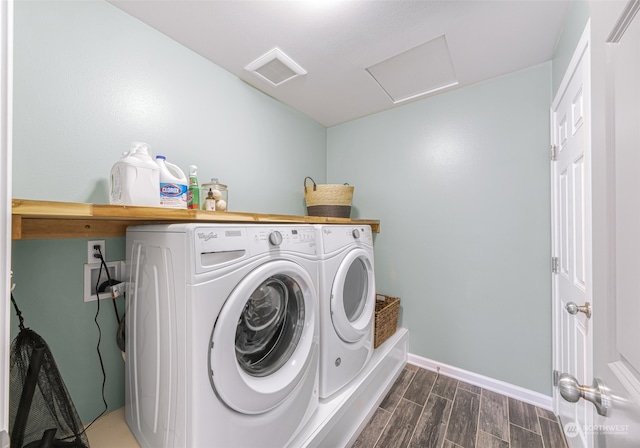 clothes washing area with dark hardwood / wood-style flooring and separate washer and dryer