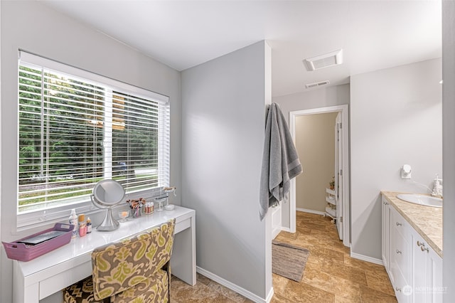 bathroom featuring tile patterned floors, vanity, and a healthy amount of sunlight