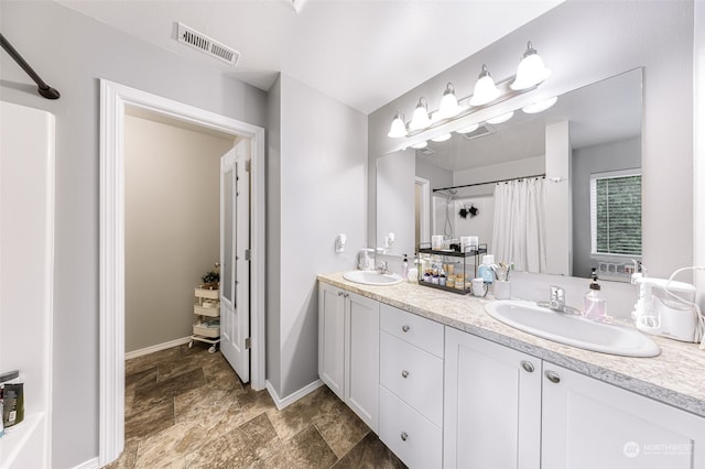 bathroom featuring double sink vanity and tile patterned floors