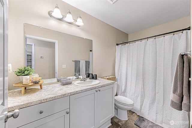 bathroom with vanity, tile patterned flooring, and toilet