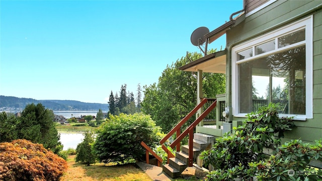 exterior space with a water and mountain view