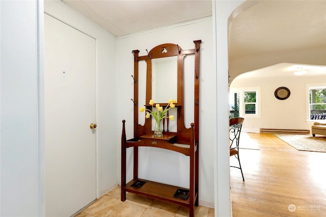 hallway with light hardwood / wood-style floors, crown molding, and a baseboard radiator