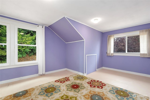 additional living space featuring vaulted ceiling and plenty of natural light