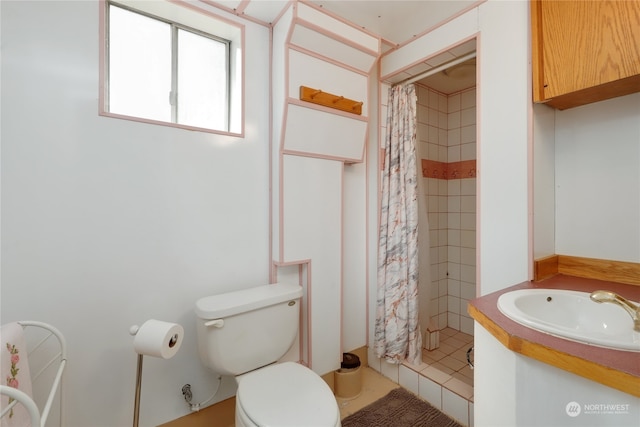 bathroom featuring toilet, vanity, and walk in shower