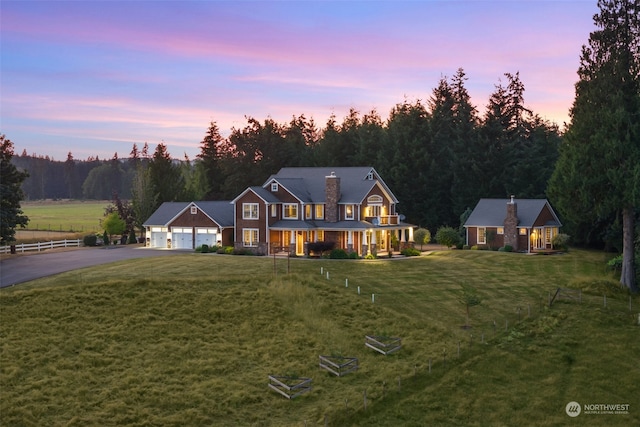 view of front of home with a garage and a lawn