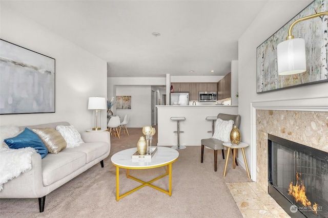 living room featuring light colored carpet and a tile fireplace