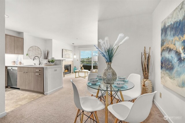 carpeted dining area with sink