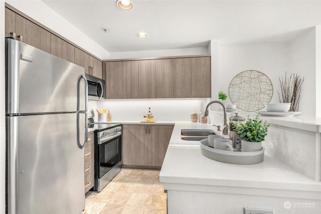 kitchen with light tile patterned floors, stainless steel appliances, and sink