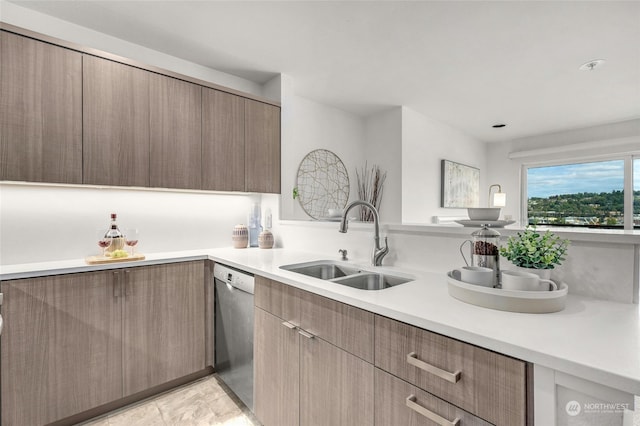 kitchen featuring sink, light tile patterned floors, and stainless steel dishwasher