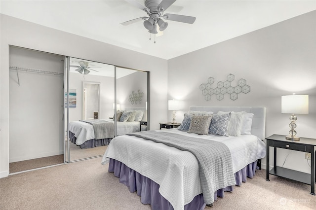 bedroom with light colored carpet, a closet, and ceiling fan