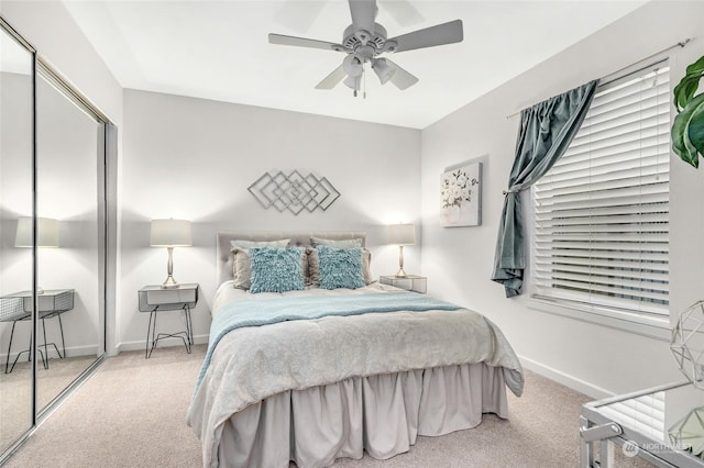 bedroom featuring ceiling fan, light colored carpet, and a closet