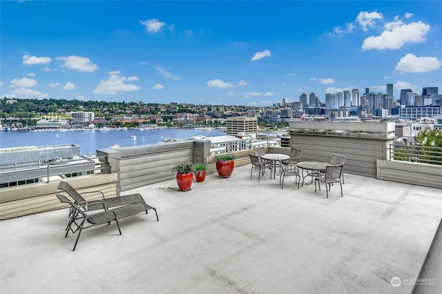 view of patio with a balcony and a water view