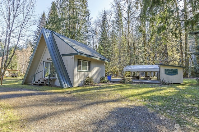 view of side of home featuring a yard and a carport