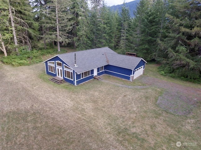 bird's eye view with a wooded view