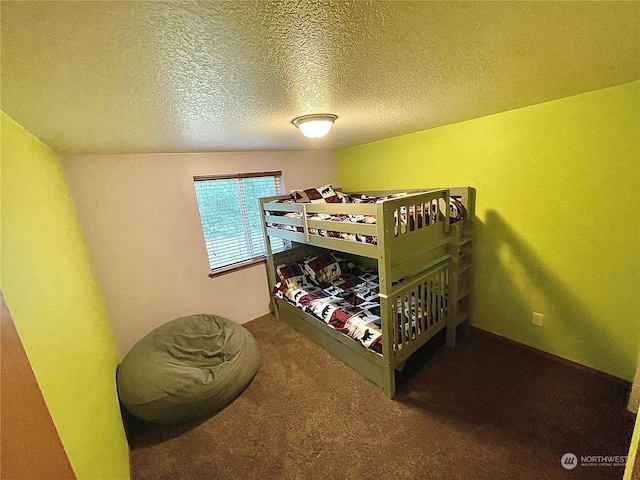 bedroom featuring a textured ceiling and carpet floors