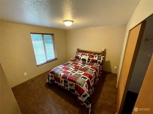 bedroom with a textured ceiling and carpet