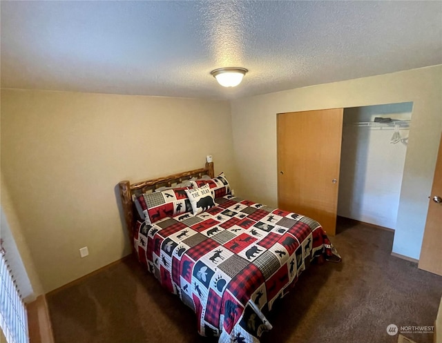 bedroom featuring a closet, dark carpet, and a textured ceiling